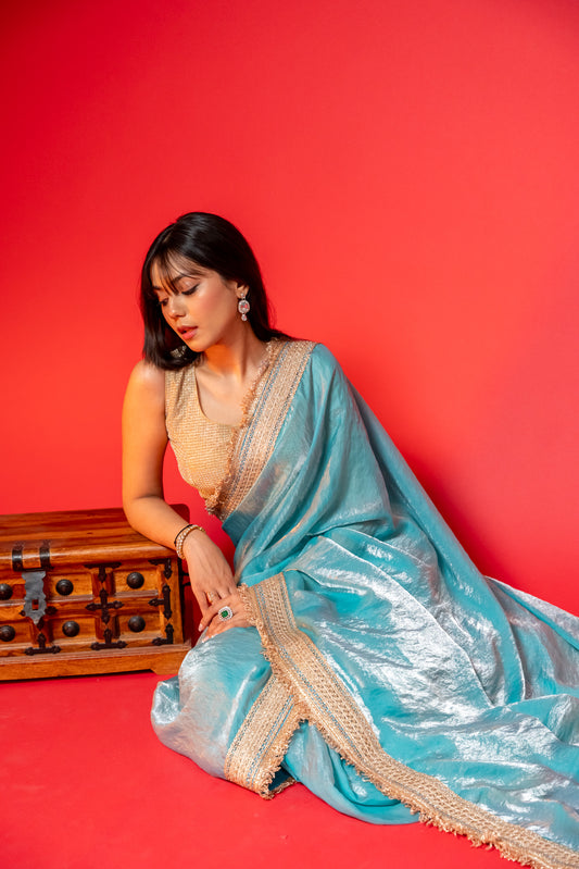 Elegant Sky Blue Tissue Saree with Golden Embellished Border